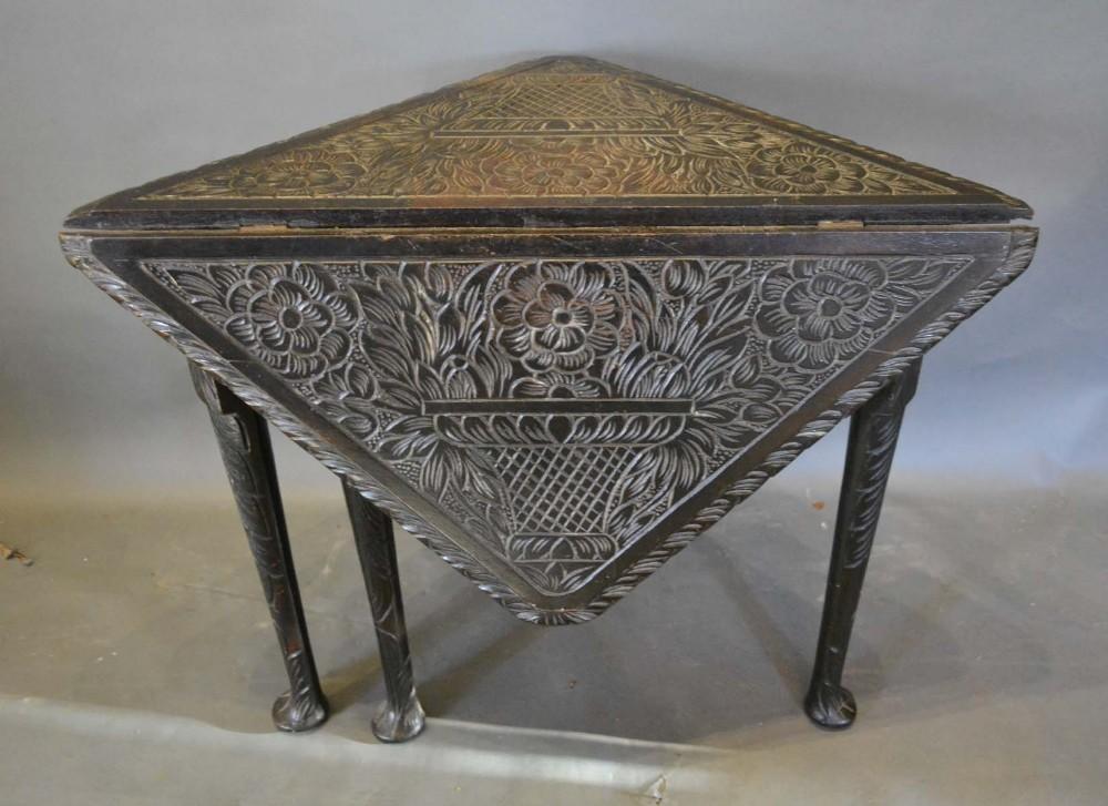 A 19th Century Carved Oak Drop Flap Table of Triangular Form, retailed by Edwards & Roberts