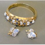 A Bangle by Trefari set with moonstones, together with a pair of matching ear clips