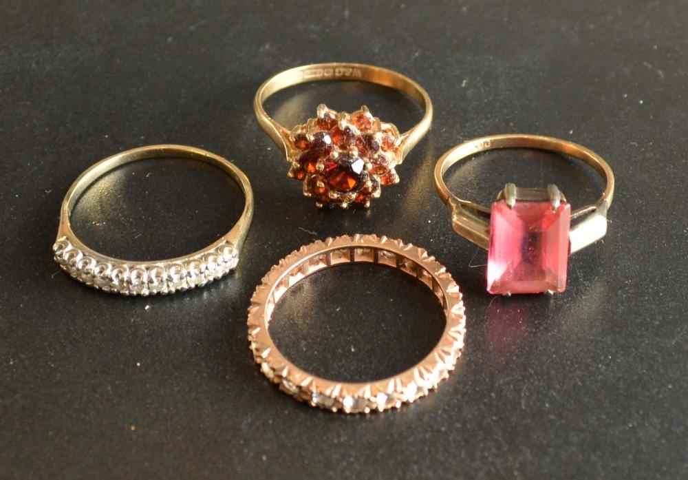 A 9 Carat Gold Garnet Cluster Ring, together with three other 9 carat gold dress rings