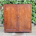 An Early 19th Century Mahogany Side Cabinet with two crossbanded doors enclosing sliding trays and