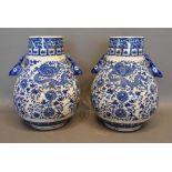 A Pair of Chinese Underglaze Blue Decorated Vases, each with serpents amongst foliage and with