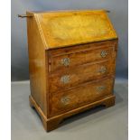 An Early 20th Century Burr Walnut Bureau, the top with two candle slides above a fall front