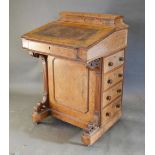 A Victorian Burr Walnut Davenport with a stationery compartment above a fall front with four drawers