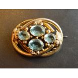 A Gold Large Brooch of oval form set with four aquamarines, 4 x 5cm
