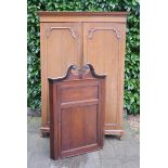 A George III Hanging Corner Cabinet, together with an oak two door wardrobe