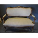 A Late 19th/Early 20th Century French Salon Sofa, the shaped carved and upholstered back above a