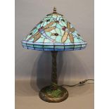 A Tiffany Style Glass and Patinated Metal Mounted Table Lamp decorated with dragonflies, 55cm tall