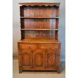 A George III Style Oak Dresser, the boarded shelf back above two drawers and two arched panel
