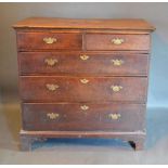 A George III Oak Chest, the star inlaid and moulded top above two short and three long drawers