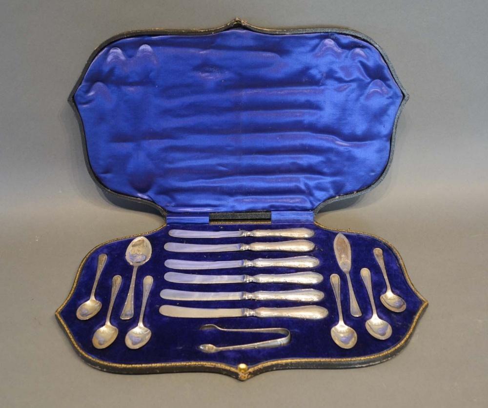 An Edwardian Silver Breakfast Set comprising knives, spoons and sugar tongs within fitted lined