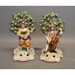A Pair of Early 19th Century Staffordshire Figures in the form of musicians before bocage with