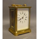 A French Brass Cased Carriage Clock, the enamel dial with Roman and Arabic numerals and with lever