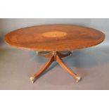 A 20th Century Mahogany Oval Coffee Table, the marquetry inlaid and crossbanded top above a turned