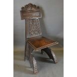 A Victorian Carved Oak Hall Chair, the carved lion mask back above a panel seat raised upon carved