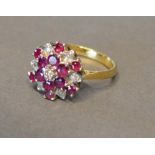 An 18 Carat Gold Diamond and Garnet Set Cluster Ring of tiered form, claw set