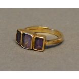 A 9 Carat Gold Dress Ring, set three amethysts