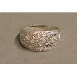 A 9 Carat White Gold Diamond Encrusted Band Ring of pierced form