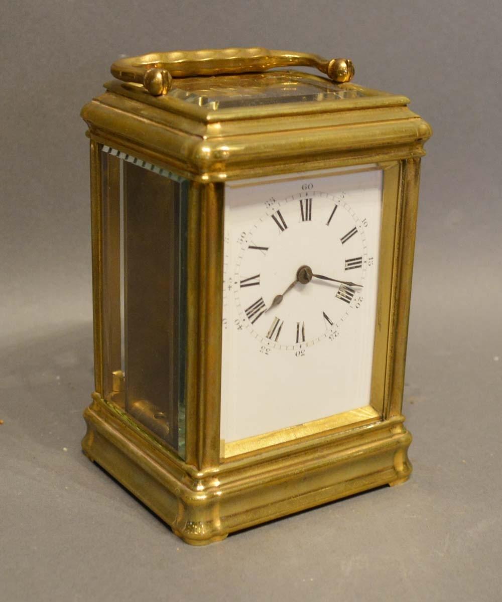 A 19th Century French Brass Gorge Cased Carriage Clock, the enamel dial with Roman and Arabic