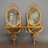 A Pair of Late 19th/Early 20th Century French Gilded Mirrored Wall Brackets, each of oval form