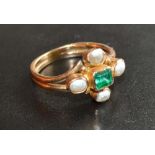 A 19th Century Yellow Metal Dress Ring set with a rectangular emerald surrounded by pearls