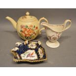 An Early 19th Century English Teapot of globular form decorated in polychrome enamels upon a cream