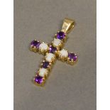 A 9 Carat Yellow Gold Pendant in the form of a cross set with amethysts and opals