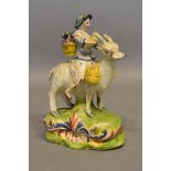 A 19th Century Pearlware Figure, Welch, Tailor's Wife Riding a Goat, 17cm tall