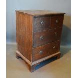 A 19th Century Oak Small Chest, the moulded top above two short and two long drawers with circular