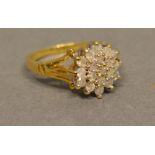 An 18 Carat Yellow Gold Diamond Cluster Ring set with many diamonds within a pierced setting