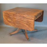 A 19th Century Mahogany Breakfast Table, the drop flap top above a frieze drawer raised upon a