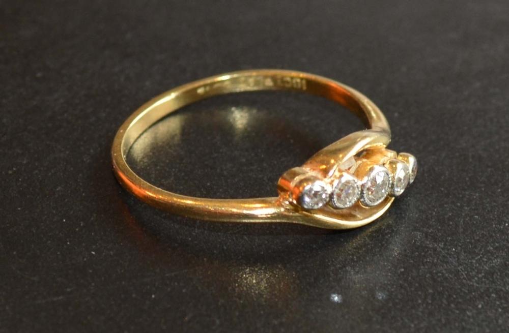 An 18 Carat Gold and Platinum Set Five Stone Diamond Ring of crossover form