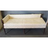 An Edwardian Mahogany Day Bed, the upholstered back and seat raised upon turned tapering reeded