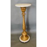 A French Carved Giltwood and Variegated Marble Torchere with a spiral twist column and circular