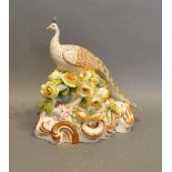 A 19th Century English Porcelain Model in the form of a peacock with foliate encrusted decoration