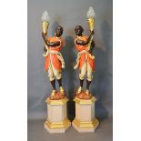 A Pair of Carved Wooden and Polychrome Decorated Blackamoor Floor Standing Lamps, each of figural