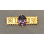 A 15 Carat Gold Bar Brooch, set oval amethyst flanked by pearls within a pierced border