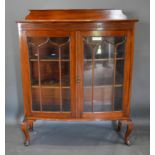 An Early 20th Century Mahogany Bow-Fronted Display Cabinet with two astragal glazed doors