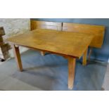 An Oak Refectory Style Extending Dining Table, the plank top above a shaped frieze raised upon