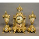 A 20th Century Brass Clock Garniture, the dial with Roman and Arabic numerals and with two train