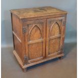 An Oak Gothic Revival Side Cabinet with two doors flanked by stiles, 64cm wide, 42cm deep, 71cm high