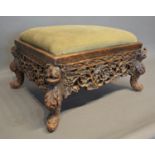 A 19th Century Black Forest Rectangular Stool, the padded top above a foliate pierced frieze