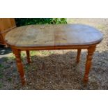 A 20th Century Pine Extending Dining Table, the moulded top above turned tapering legs with integral