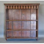 A George III Oak Plate Rack, the moulded cornice above three shelves with boarded back, 102cm