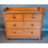 A Victorian Mahogany Chest, the low galleried back above two short and two long drawers with knob