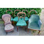 A Set of Four Victorian Walnut Balloon Back Dining Room Chairs, each with a shaped carved rail