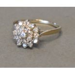 An Unmarked White Gold Diamond Cluster Ring of Tiered Form, claw set