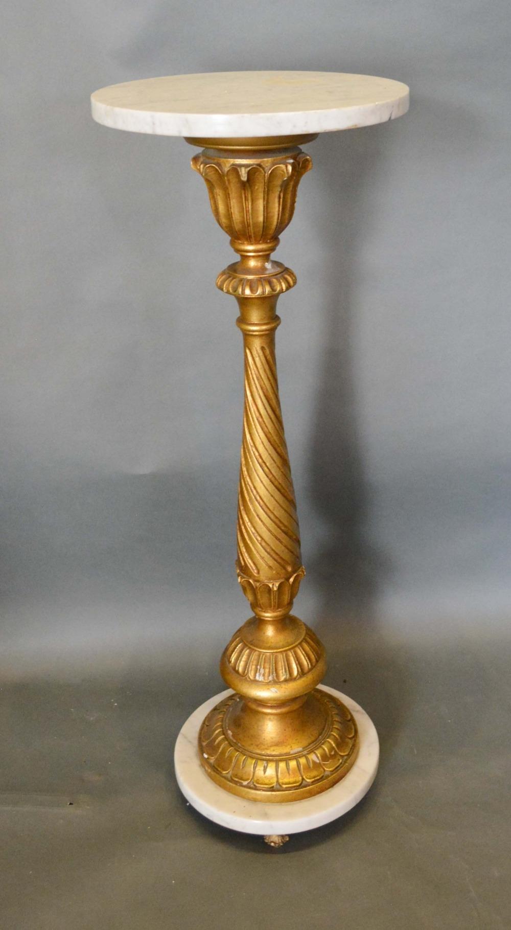 A French Carved Giltwood and Variegated Marble Torchere with a spiral twist column and circular
