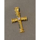 An 18 Carat Gold Solitaire Diamond Set Pendant in the form of a crucifix by Theo Fennell, 3.4