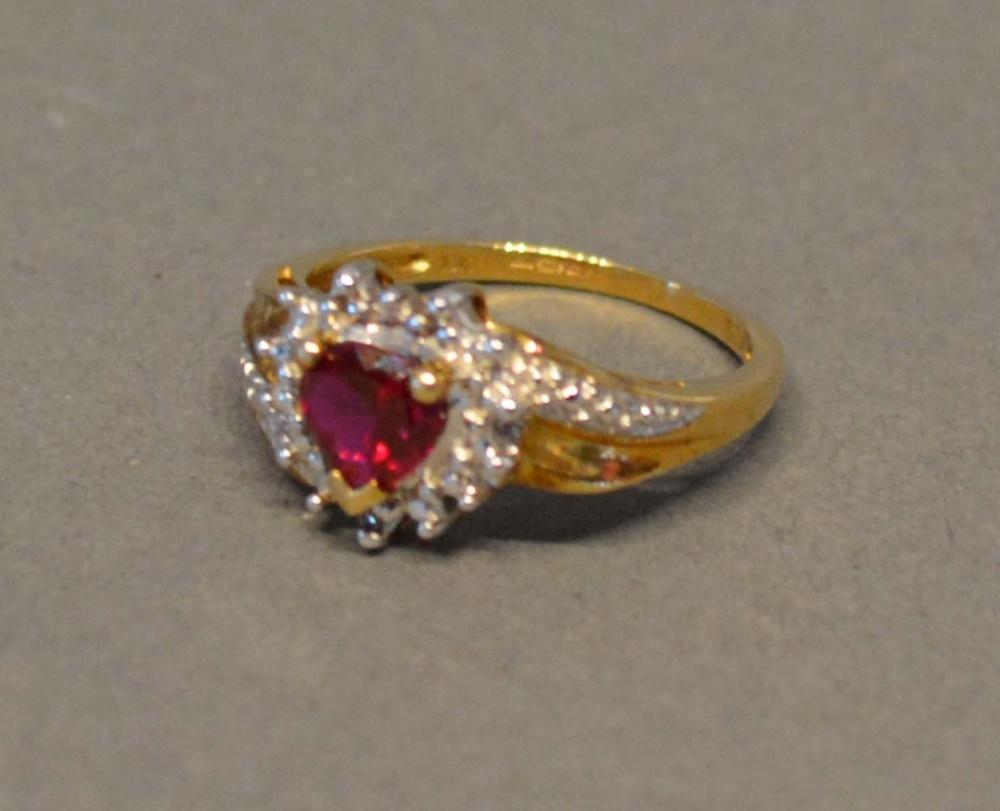 A 9 Carat Gold Ring of Heart Form with a red stone surrounded by diamonds