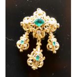 A Yellow Metal Brooch of pierced form with three drops set with emeralds and diamonds, a pair of